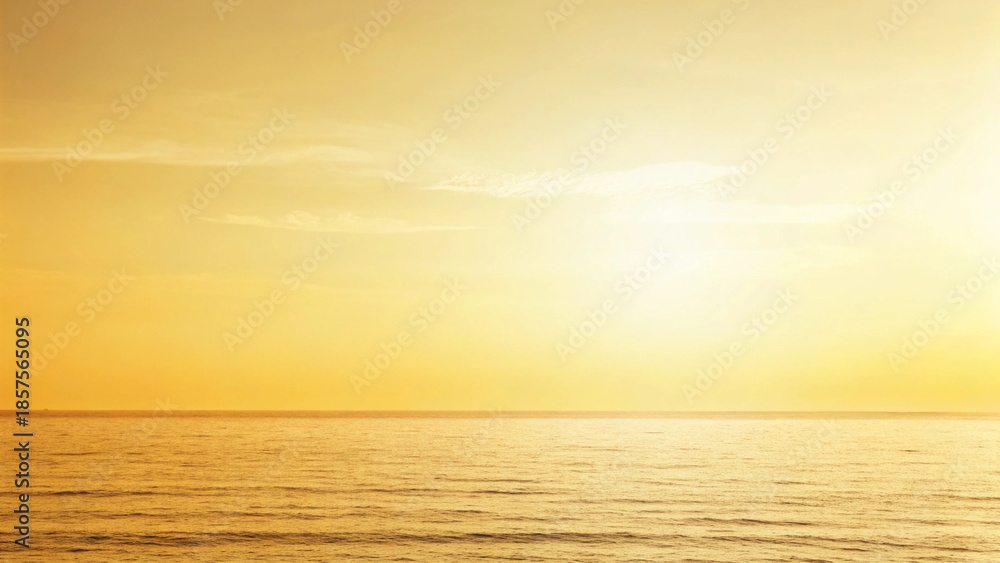 Fototapeta premium Golden Ocean and Sky at Sunset with Wispy Clouds water Background