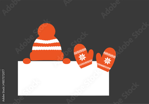 Cozy orange winter hat and mittens on a dark background