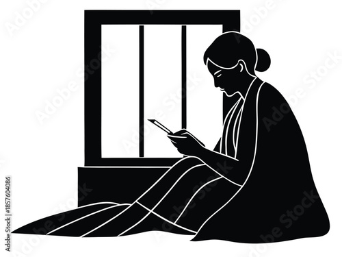 Woman sitting on floor using mobile phone near window