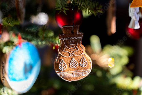 Homemade cookie decorating the christmas tree in harsh sunlight, shallow depth of field .