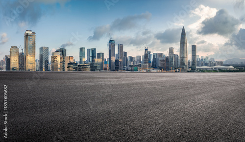 Empty asphalt road and modern city skyline with skyscrapers.