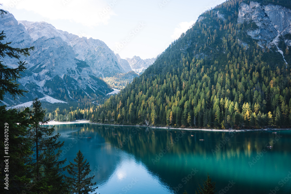 Fototapeta premium Mountain Lake Scene - Lago di Braies Italy Dolomites, Emerald green lake with mountains, alpine trees and alps landscapes - jigsaw puzzle and chocolate box perfect - sunny autumn fall day
