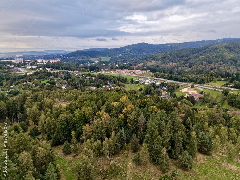 Obraz premium Mixed Forest Hills With Village Scene, Elevated Woodland Hills Gazing Upon Quaint Town And Farmland