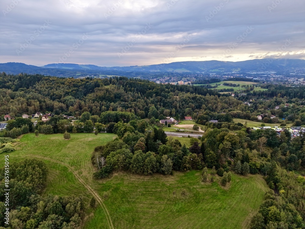Obraz premium Serene Rural Areas Meet City Outskirts, Peaceful Farmlands Stretch Toward Distant City Skyline