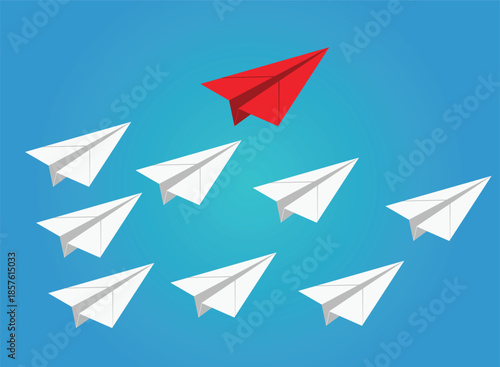 Red paper airplane leads group of white airplanes flying against blue sky background