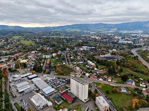 Bild auf Leinwand Urban Tower Amidst Shops And Hills, Commercial Structure Surrounded By Residenti