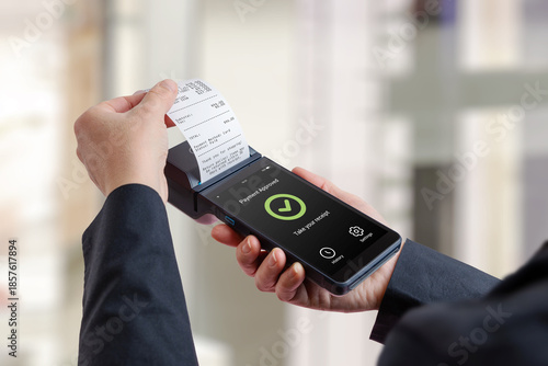 Customer holding portable POS terminal with printed receipt and approved payment screen, representing successful checkout, retail transaction completion, and modern electronic payment systems