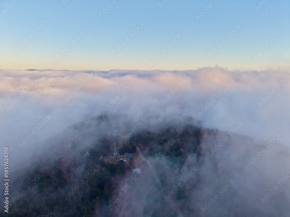 Fototapeta premium Misty Morning Over Village Landscape, Village Skyline Revealed Through Morning Fog And Gentle Light