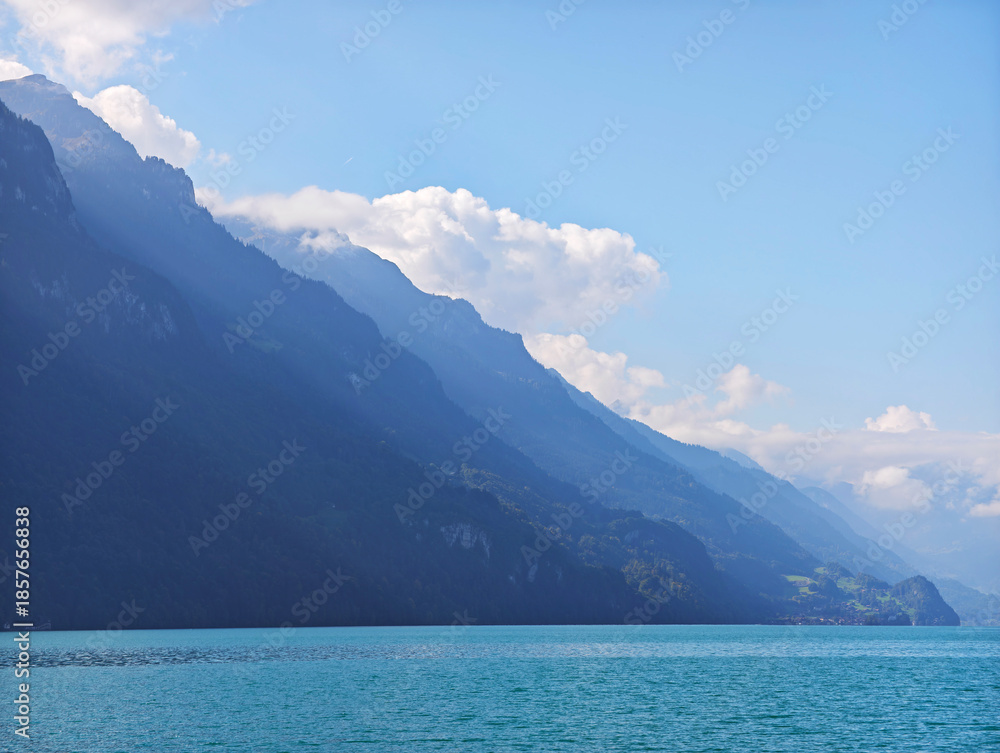 Obraz premium Iseltwald Alps mountain silhouette, turquoise water and mountain on Lake Brienz Switzerland