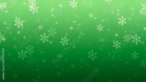 Delicate snowflakes falling against green background