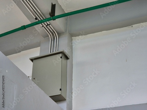 Canvas Print Electrical junction box with exposed conduit pipes mounted on white interior wal