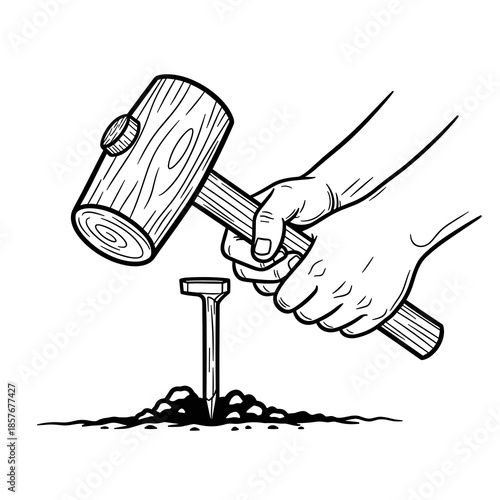 Hand holding wooden mallet striking metal tent peg into the ground  