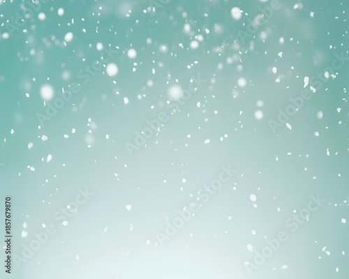 Heavy white snowfall on bright light aqua green gradient background creating soft serene frozen winter holiday atmosphere