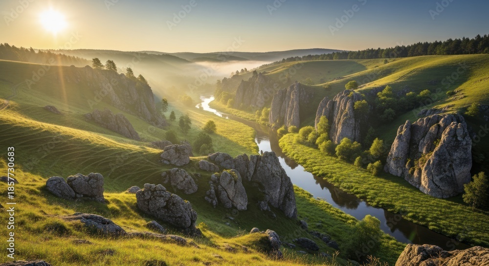 Obraz premium Morning sunlight illuminates a winding river flowing through a valley flanked by grassy hills and rugged rock formations