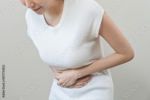 Wallpaper Mural Flatulence asian young woman intolerance hand in stomach ache, suffer from food poisoning, abdominal pain and colon problem, gastritis or diarrhoea when at home. Patient belly, abdomen or inflammation Torontodigital.ca