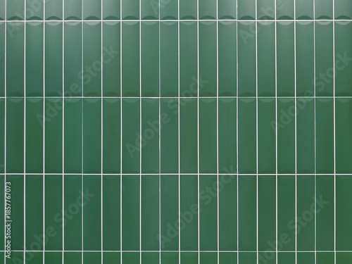 Green tile wall background with clean geometric pattern. Ceramic surface design suitable for interior, bathroom, kitchen, architecture, and decorative concepts.