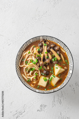Japanese udon soup with Shimeji mushrooms, tofu, and rich dark umami broth