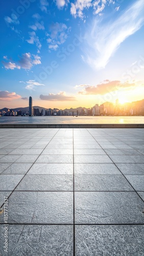 Sunset Over City Skyline with Clear Sky and Reflective Pavement
