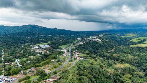 High Angle Aerial View of a Highway Crossing Through Tropical Mountain Settlements