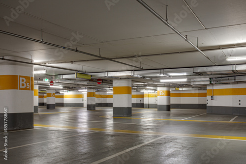 Empty Underground Parking Garage With Yellow Columns