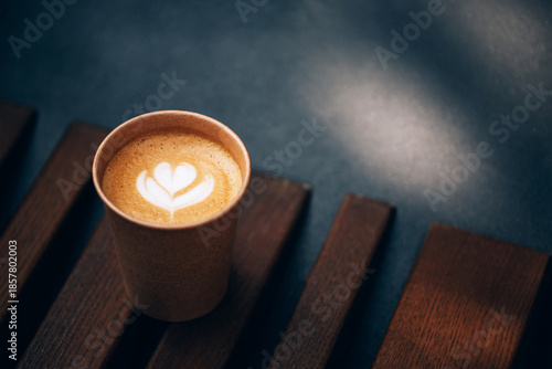 Paper cup of Coffee take-away, top view. Wooden table and place for text.