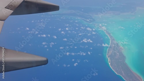 Beautiful view of Caribbean Sea coastline seen from airplane window on background of blue water and sky. Curacao.