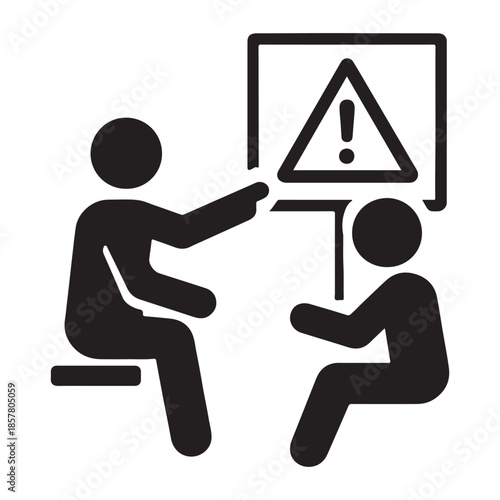 Person pointing to warning sign during safety training session with another person.