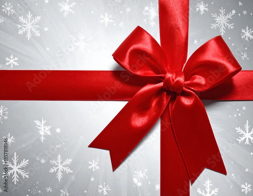 Gift wrapped Red ribbon on silver snowflake background with bokeh light