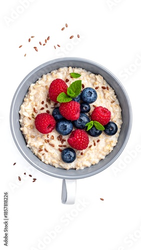 Oatmeal bowl with berries and flax seeds, white background, overhead shot