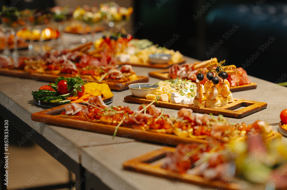 Fototapeta premium Vibrant Grazing Table Overflowing With Cheeses And Charcuterie, Corporate Launch Setting With Wooden Platters, Fig And Honey