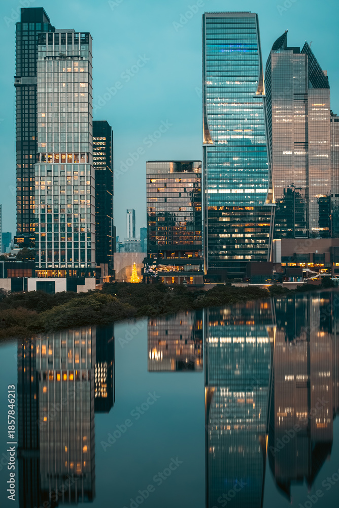 Fototapeta premium big city skyline at sunset with mirrored water reflection, modern high-rise skyscrapers at golden hour urban dusk, downtown mirroring on swimming pool, Bangkok Thailand