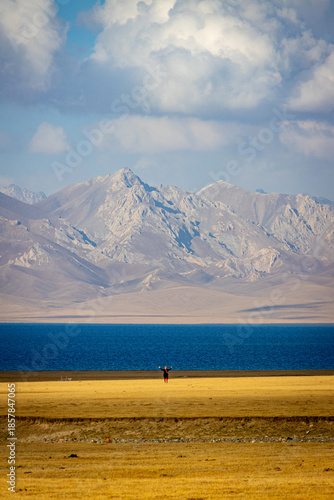Song Kul lake with the Tien Shan Mountains in the backgroound in Kyrgyzstan. Yurt camp at the shore of the lake.