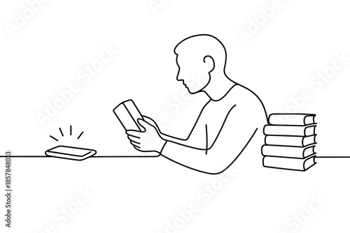 Man reading a book with a smartphone and stack of books nearby