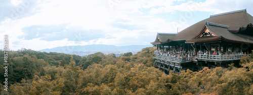 An ultra-wide panoramic view of the Kiyomizu-dera Temple wooden stage and the Kyoto city skyline