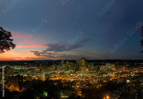 Skyline of Birmingham at sunset with lights shining in the city
