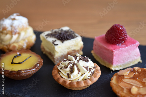 Close-up of petits fours on black slate board