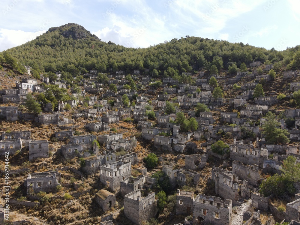 Obraz premium Aerial view of Kayaköy, a historic abandoned village set on a hillside near Fethiye, Turkey