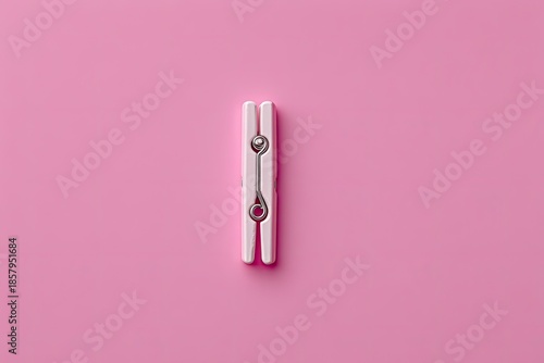 Single pink & white clothespin, centered, on a plain pink backdrop