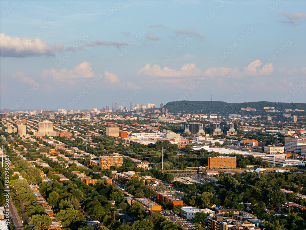 Obraz premium Aerial view of Ahuntsic Park with pond, trees and surrounding urban neighborhood in summer. g.