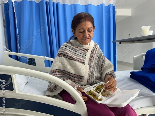 Female Patient Eating Meal While Sitting on Hospital Bed