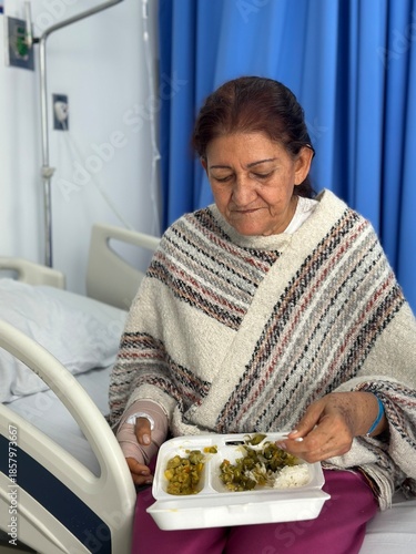 Female Patient Eating Meal While Sitting on Hospital Bed