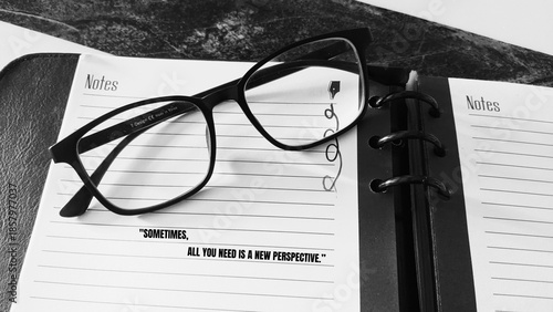 Slika na platnu Eyeglasses on notebook emphasize clarity, reflection, and the power of shifting perspective through thoughtful observation