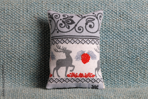 Festive cushion with deer on a sofa