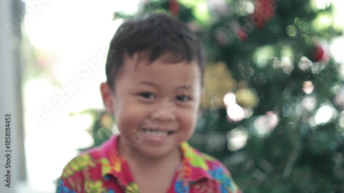 portrait of a boy on blur tree Christmas 