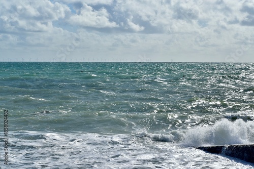 Canvas Print Waves on the sea with wind turbines on the horizon, The English Channel, Brighto