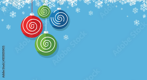 Festive holiday ornaments hang against a backdrop of falling snowflakes and a clear blue sky creating a celebratory winter scene for seasonal graphics