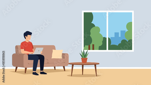 Man working on laptop while sitting on couch in a serene living room with a view of trees outside the window