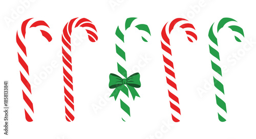 Festive row of red and green striped candy canes with one center piece decorated by a green ribbon bow on a solid white background.