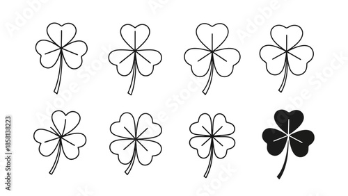 A collection of stylized clover leaf illustrations, featuring both three-leaf and four-leaf varieties, with one black clover.
