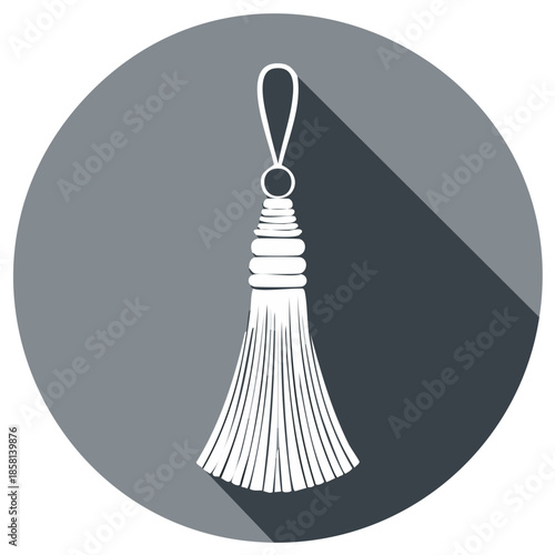 White tassel with loop and shadow on a dark gray circular background